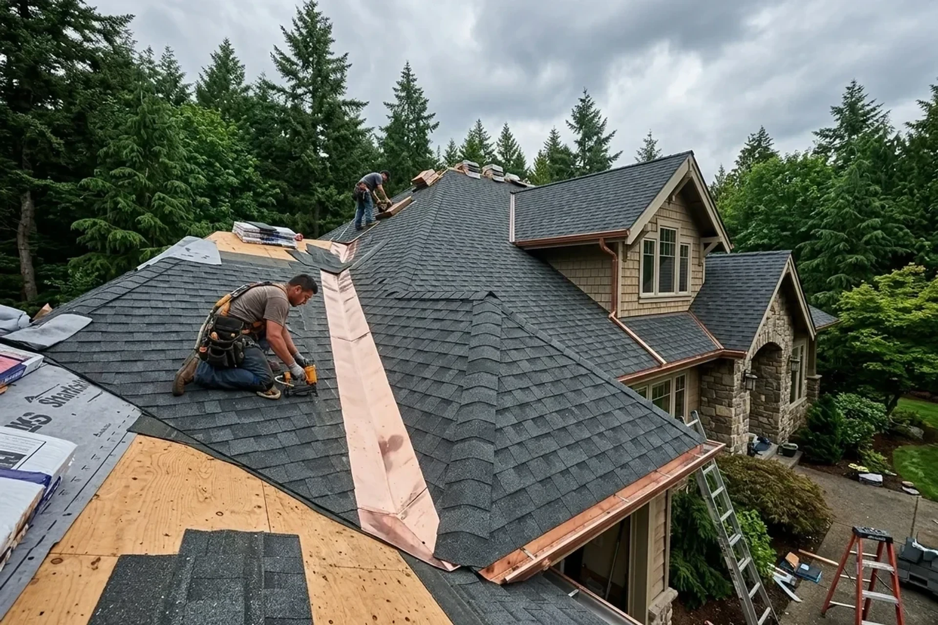 Experienced Clark County roofing craftsmen installing architectural shingles with precision copper valley flashing on a residential Vancouver WA home